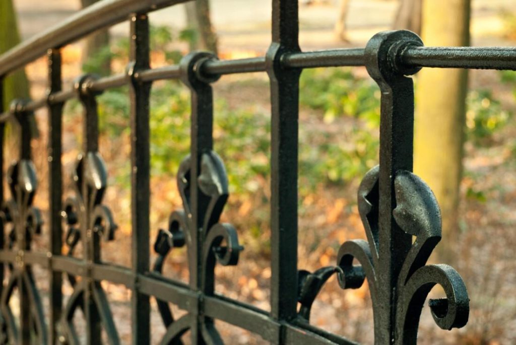Close up picture of a black iron fence