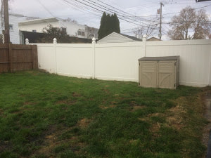 A Picture Of A White Vinyl Fence Installed On A Small Plot Of Land Delco Fencing