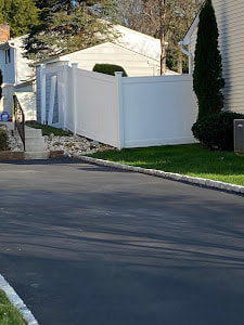 A Picture Of A White Vinyl Fence Installed By A Customer But Could Not Figure Out How To Finish It And Had Some Issues With Grading And Moving So He Called Delco Fencing To Come In And Finish And Re Do What He Did