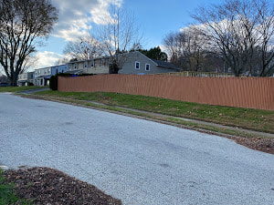A Long Wooden Fence That Was Painted And Repaired A Couple Years Ago And Getting Ready For Replacement By Delco Fencing